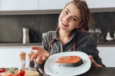 Young girl with trout steak